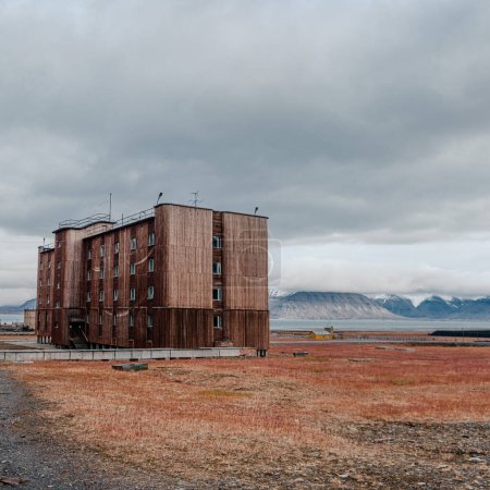 Large abandoned Soviet building in the stark landscape of Pyramiden, Svalbard