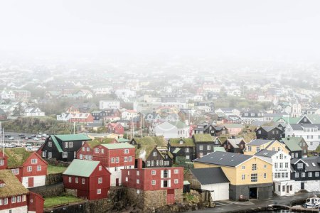 Misty morning over the colorful cityscape of Thorshavn, Faroe Islands.
