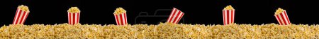 Scattered popcorn from paper striped bucket isolated on black background, concept of watching TV or cinema.
