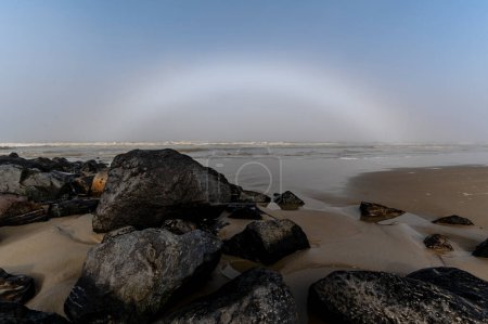 Seltener weißer Regenbogennebel am Strand von Ameland am frühen Morgen des Jahres 2021