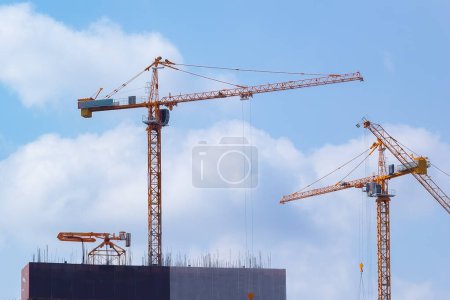 about the details of the tower crane at a construction site at noon among sunshine