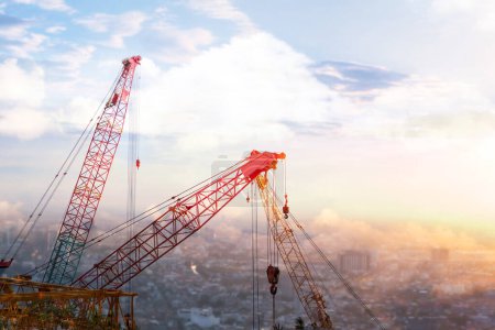 Photo for The tower crane and mobile crane and collar crane and construction site in the afternoon time with sunset. there are slings, and hooks, to try to build the city. - Royalty Free Image