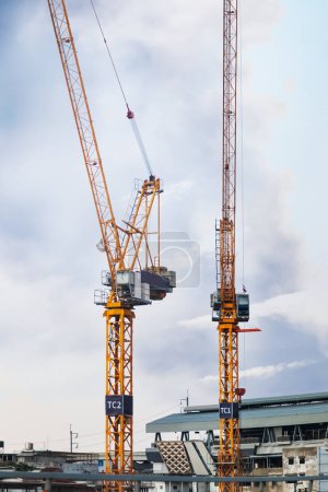 A towering crane stands as the sentinel of progress. Its massive steel frame reaches towards the sky, the crane orchestrates the ballet of construction.
