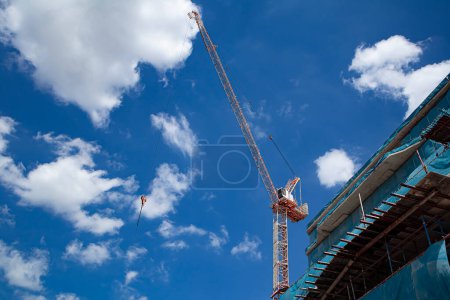Photo for About the tower crane at the construction site and blue sky by emphasizing the tower crane - Royalty Free Image