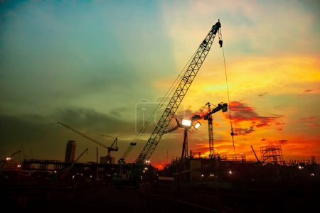 about the tower crane at a construction site when sunset and colour full