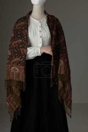 A mannequin with human hands wearing a Victorian Garibaldi blouse and black skirt. A human head can be added to the image. 