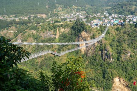 Photo for A suspension bridge with bungee jumping across a deep gorge in Kushma, Nepal. - Royalty Free Image