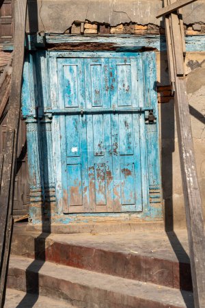 A closed wooden door in an old building in Kathmandu, Nepal.