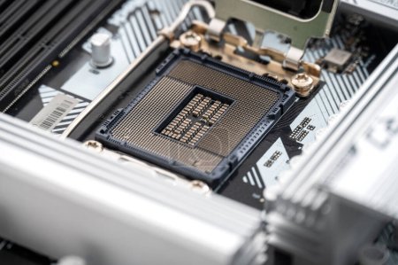 Detailed close-up view of an empty CPU socket on a sleek, modern motherboard. The image showcases intricate technology components used in advanced computing systems.
