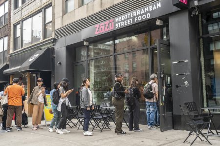 Foto de Nueva York NY USA-May 17, 2024 La gente espera en la cola en la gran reapertura de Zazu Mediterranean Street Food en el barrio de Chelsea en Nueva York - Imagen libre de derechos