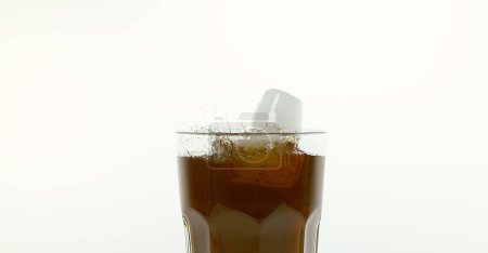 Photo for Ice Cubes Falling into Glass of Coke against White Background - Royalty Free Image