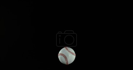 Photo for Ball of Baseball breaking Pane of Glass against Black Background - Royalty Free Image