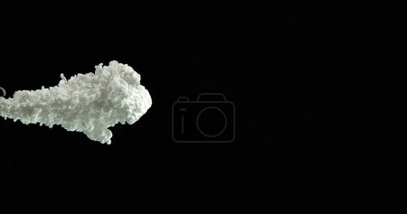 Photo for White Ink entering Water against Black Background - Royalty Free Image