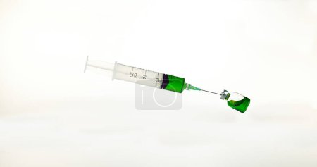 Photo for Syringe Falling against White Background - Royalty Free Image