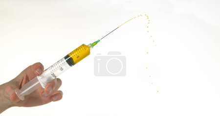 Photo for Liquid squirting from Needle against White Background - Royalty Free Image