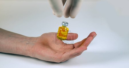 Photo for Medical Product Falling into Hand against White Background - Royalty Free Image