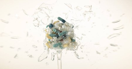 Photo for Glass filled with Capsules Exploding against White Background - Royalty Free Image