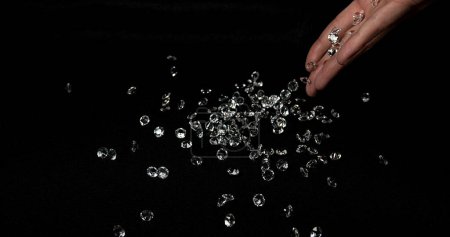 Photo for Hand of Woman with Diamonds against Black Background - Royalty Free Image