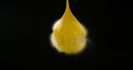 Photo for Shot Breaking Water Filled Yellow Balloon - Royalty Free Image