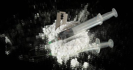 Photo for Powder Drug Falling on Razor Blade and Syringes against Black Background - Royalty Free Image