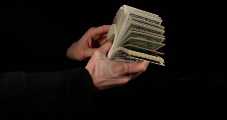 Photo for Hand of Woman and Dollar Bank Notes against Black Background - Royalty Free Image
