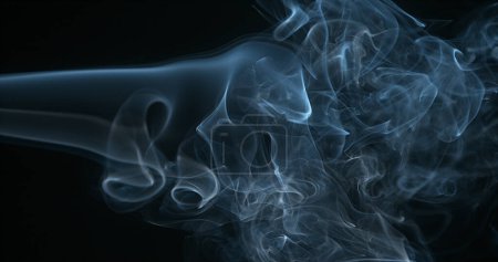 Photo for Smoke of Cigarette rising against Black Background - Royalty Free Image
