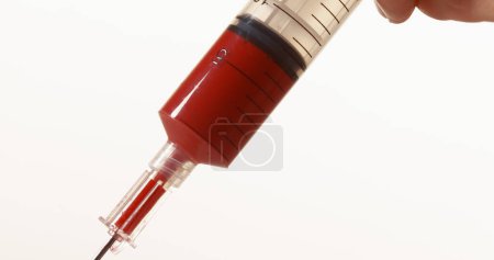 Photo for Blood dropping from Needle against White Background - Royalty Free Image