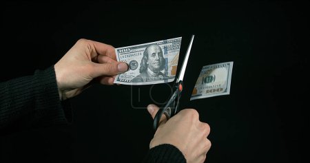 Photo for 1 US Dollar Banknote with a pair of scissors against Black Background - Royalty Free Image