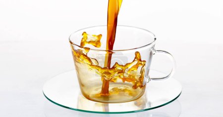 Photo for Coffee Being Poured in a Cup against White Background - Royalty Free Image
