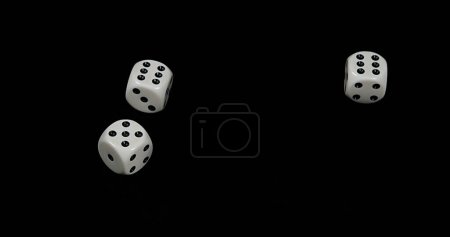 Photo for Dice rolling against Black background - Royalty Free Image