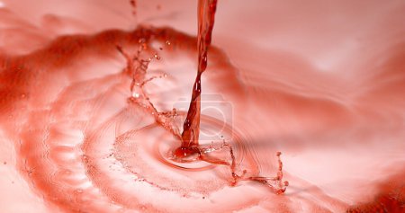 Photo for Red Wine being poured against White Background - Royalty Free Image