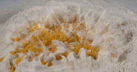 Photo for Pasta falling on flour - Royalty Free Image