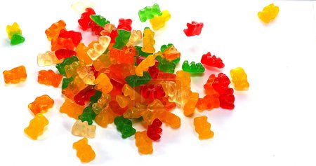 Photo for Gold Bears or Gummy Bears falling against White Background - Royalty Free Image