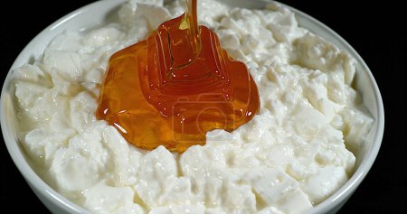 Photo for Honey that falls on White Cheese - Royalty Free Image