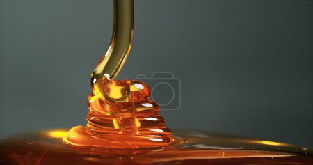Photo for Honey Flowing against Black Background - Royalty Free Image