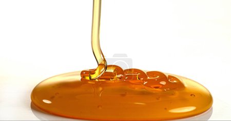Photo for Honey Flowing against White Background - Royalty Free Image