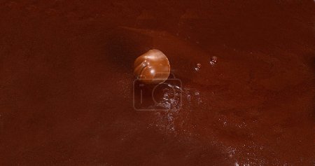 Photo for Chocolate falling into Milk Chocolate - Royalty Free Image