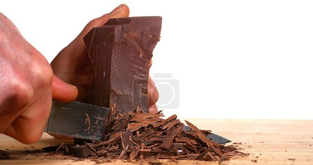 Photo for Man Cutting Black Chocolate with Knife - Royalty Free Image