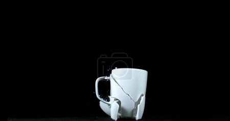 Photo for Cup falling and exploding on Black Background - Royalty Free Image