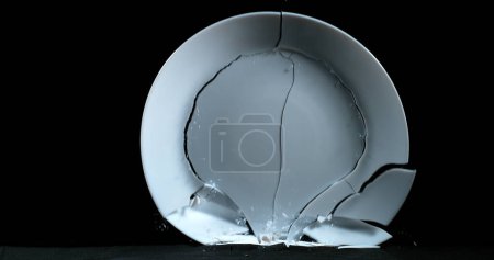 Photo for Plate falling and exploding on Black Background - Royalty Free Image