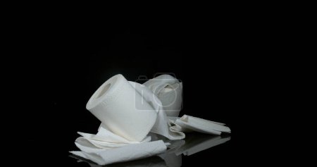 Photo for Roll of Toilet Paper Falling on Black Background - Royalty Free Image
