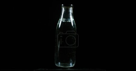 Photo for Bottle Falling on Black Background - Royalty Free Image