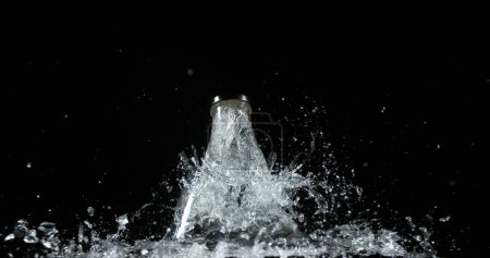 Photo for Bottle Falling and exploding on Black Background - Royalty Free Image