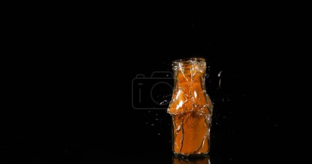 Photo for Turmeric, curcuma longa, Powder in a Small Jar Exploding against Black Background, Indian Spice - Royalty Free Image