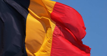 Photo for Belgian Flag Waving in the Wind against blue sky - Royalty Free Image