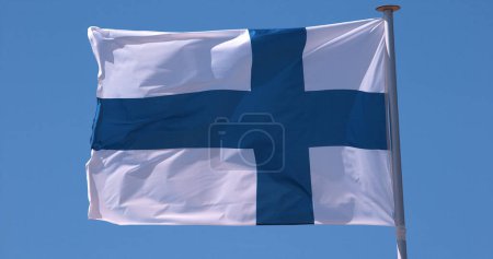Photo for Finnish Flag Waving in the Wind against blue sky - Royalty Free Image