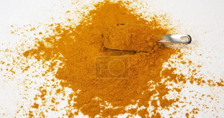 Photo for Curry Powder falling against white background - Royalty Free Image