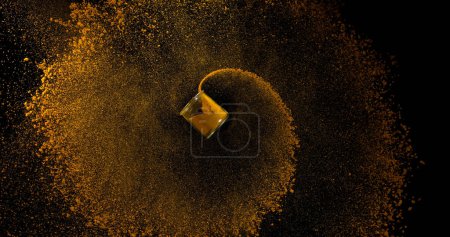 Photo for Curry Powder into a Small Jar falling against Black Background - Royalty Free Image