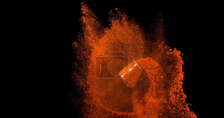 Photo for Paprika, capsicum annuum, Powder in a Small Jar falling against Black Background - Royalty Free Image