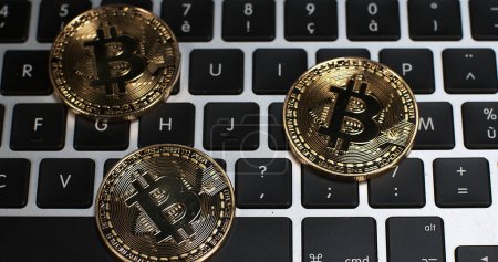 Photo for Bitcoins on Computer Keyboard Background - Royalty Free Image